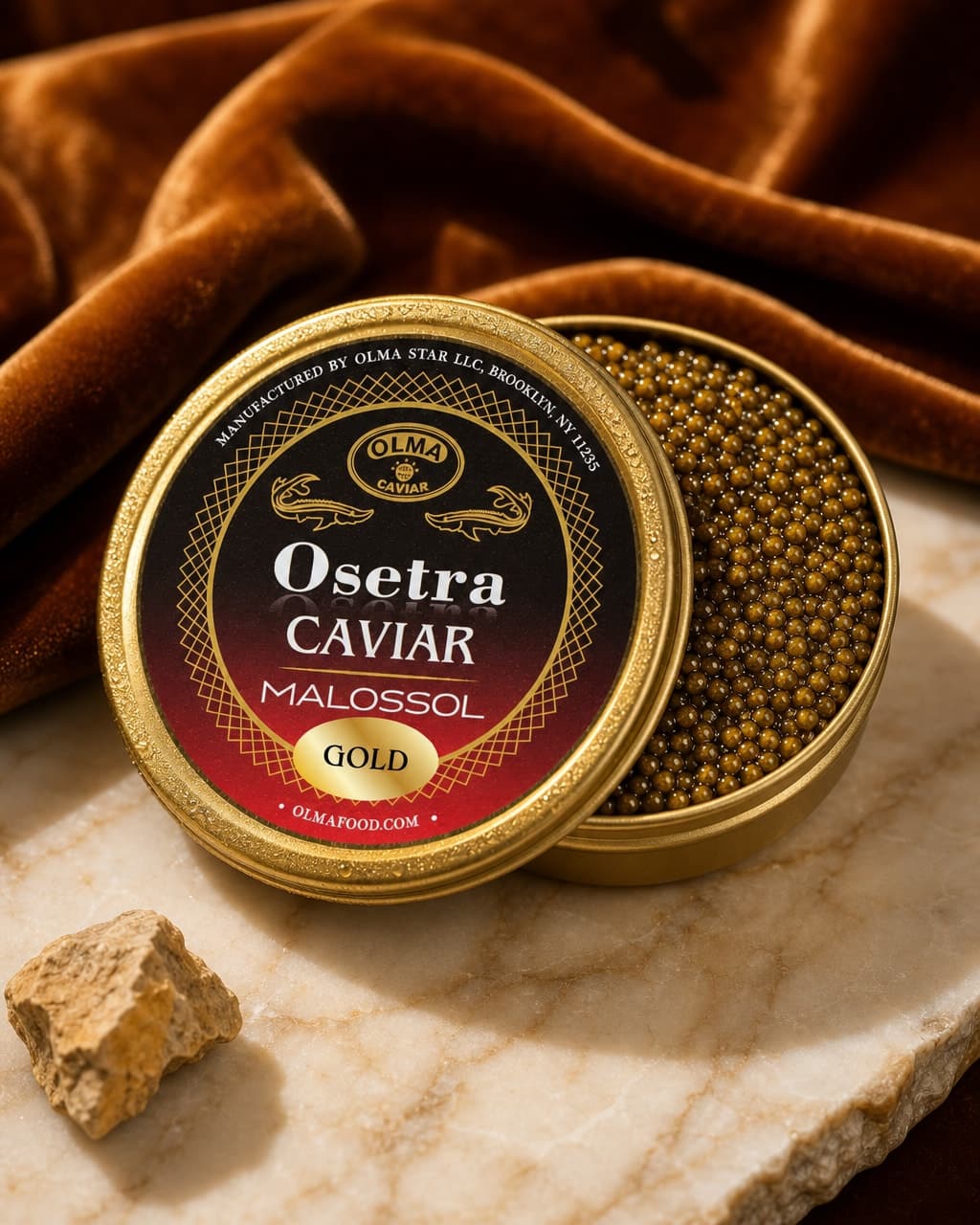 Open tin of Osetra caviar with golden label and caviar beads spilling from the lid on a marble surface, with brown velvet backdrop.